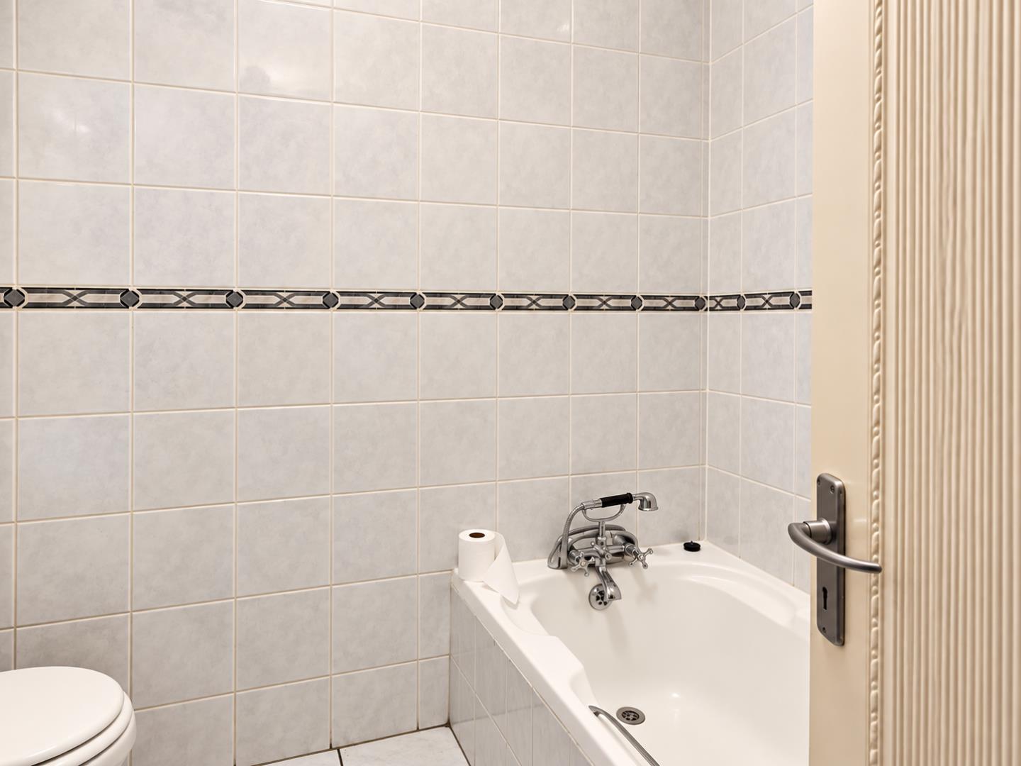769695_Retro_Chrome_Fixtures_in_a_Marble-Tiled_Bathroom.png