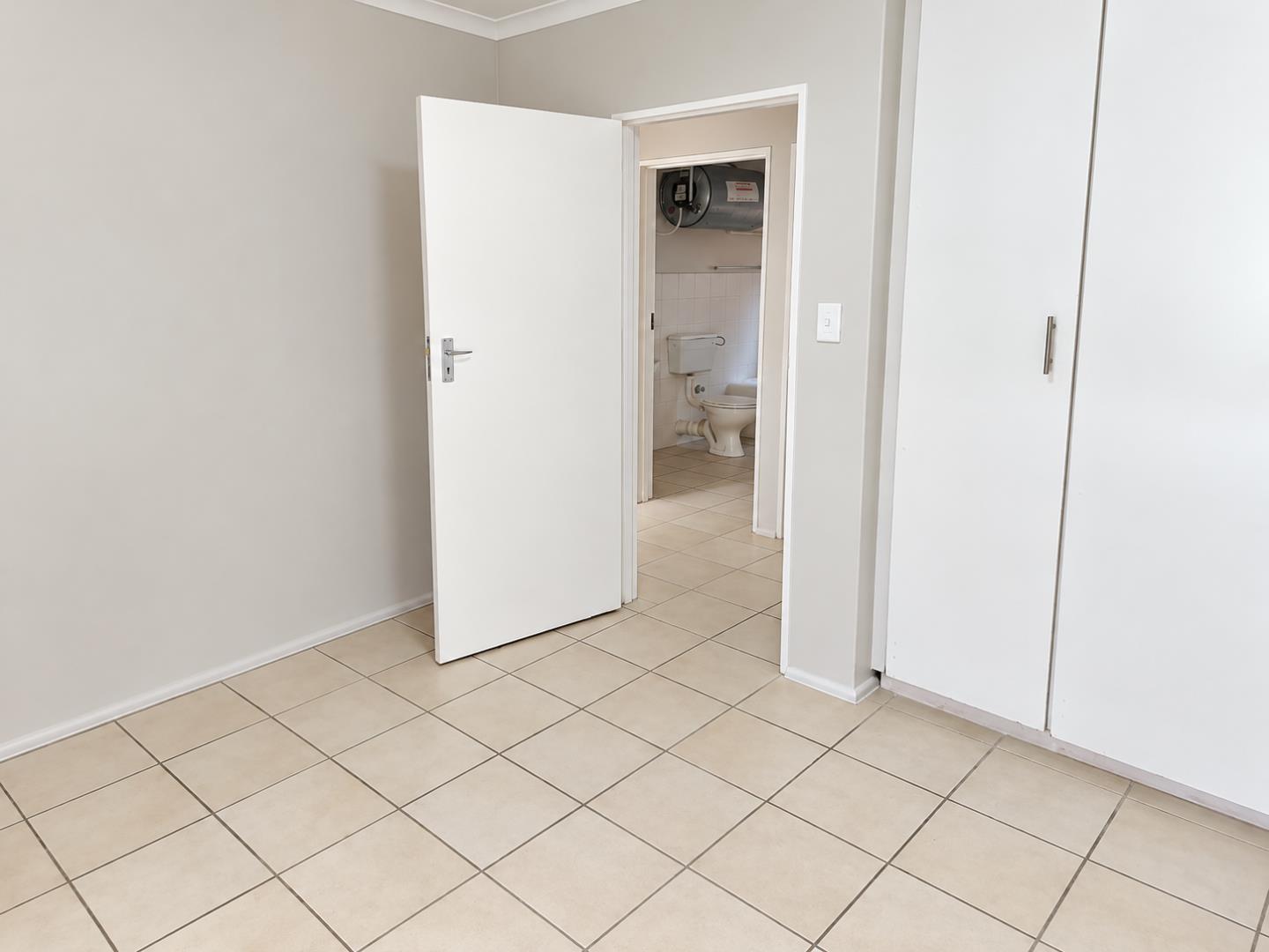 769798_Minimal_Room_with_Open_Bathroom_Door.png
