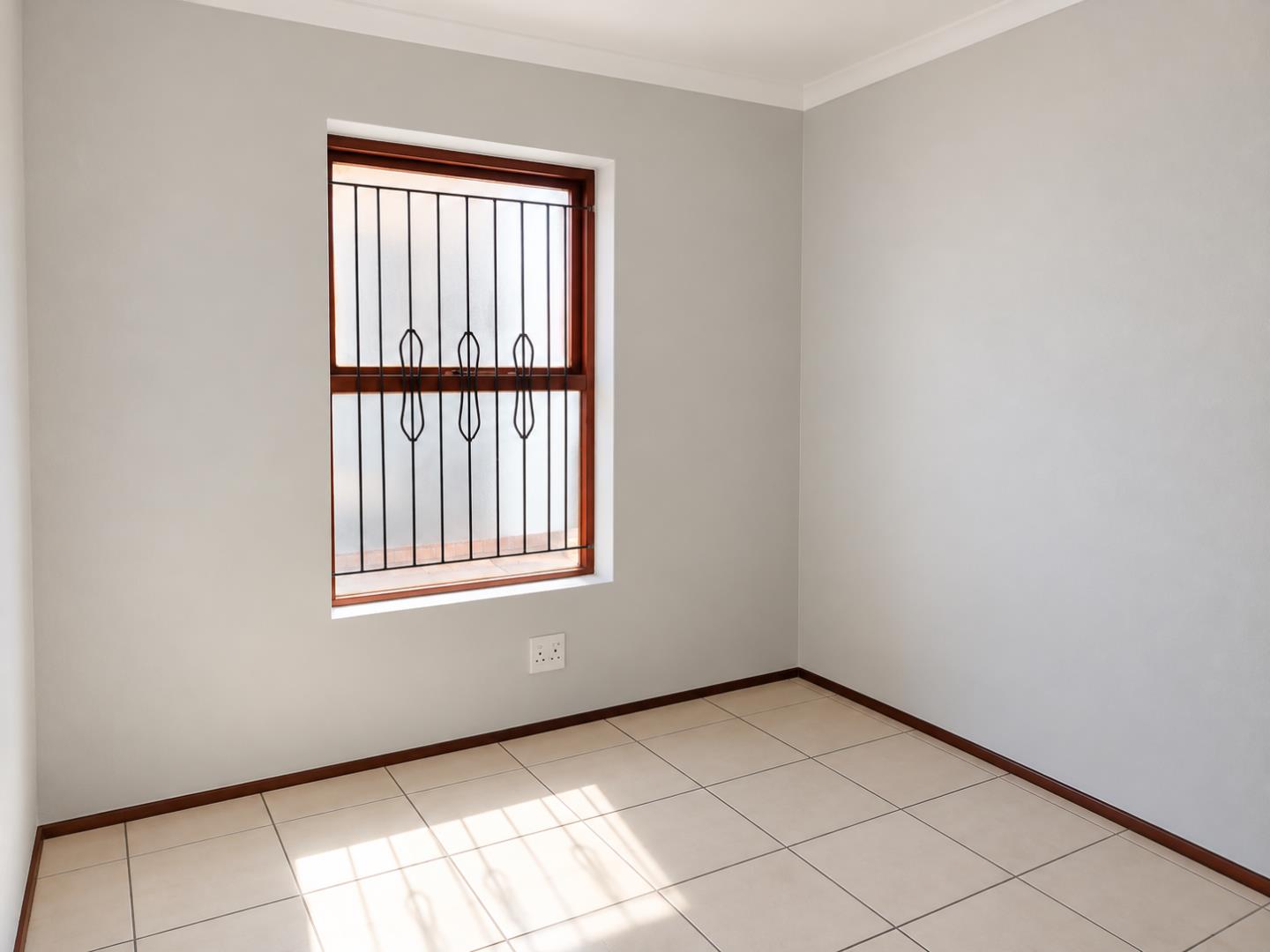 769803_Empty_Sunlit_Room_with_Grilled_Window.png