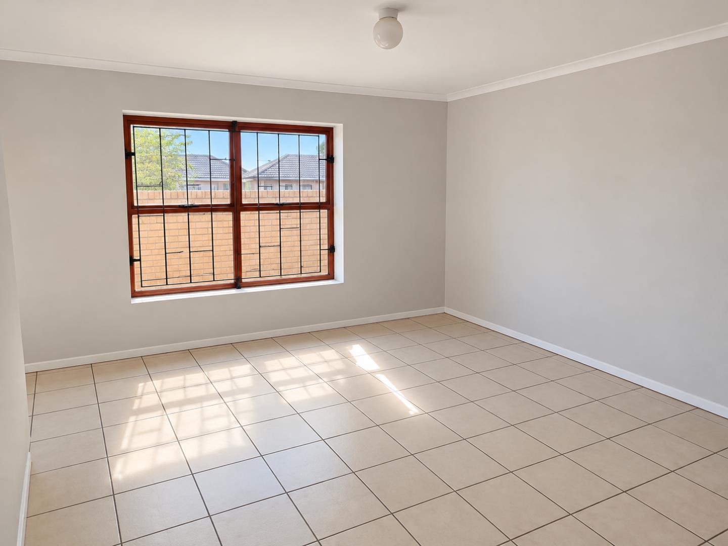 769803_Sunlit_Empty_Room_with_Grilled_Window.png