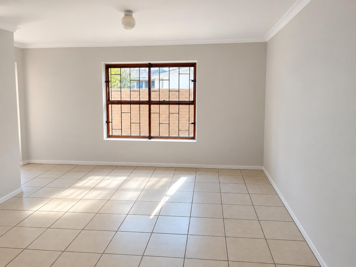 769803_Sunlit_Minimal_Room_with_Grilled_Window.png