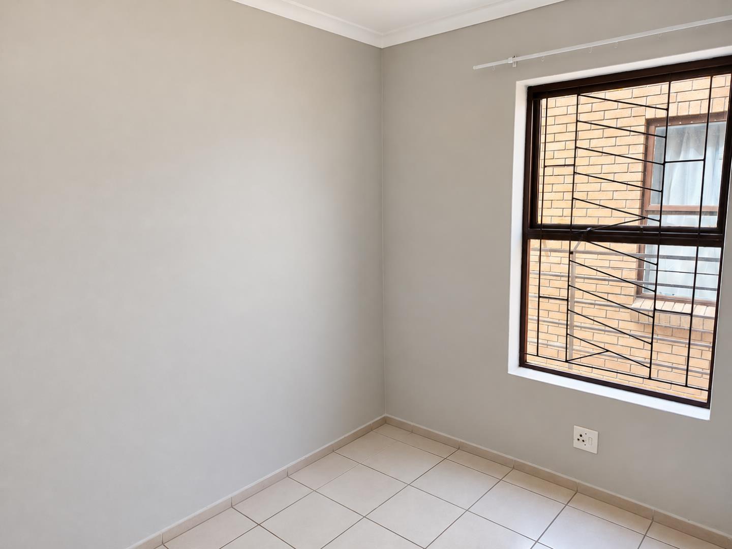 769852_Clean_Empty_Room_with_Grilled_Window.png