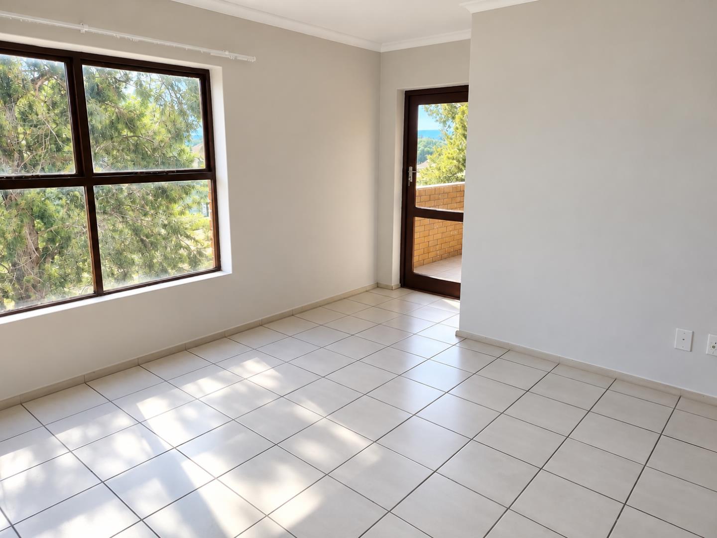 769852_Sunlit_Empty_Apartment_with_Balcony_View.png