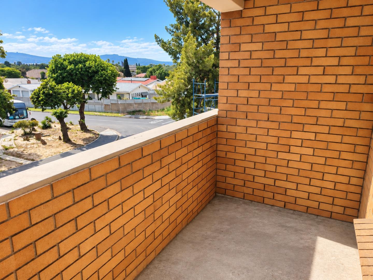 769852_Sunny_Brick_Balcony_Overlooking_Suburbia.png