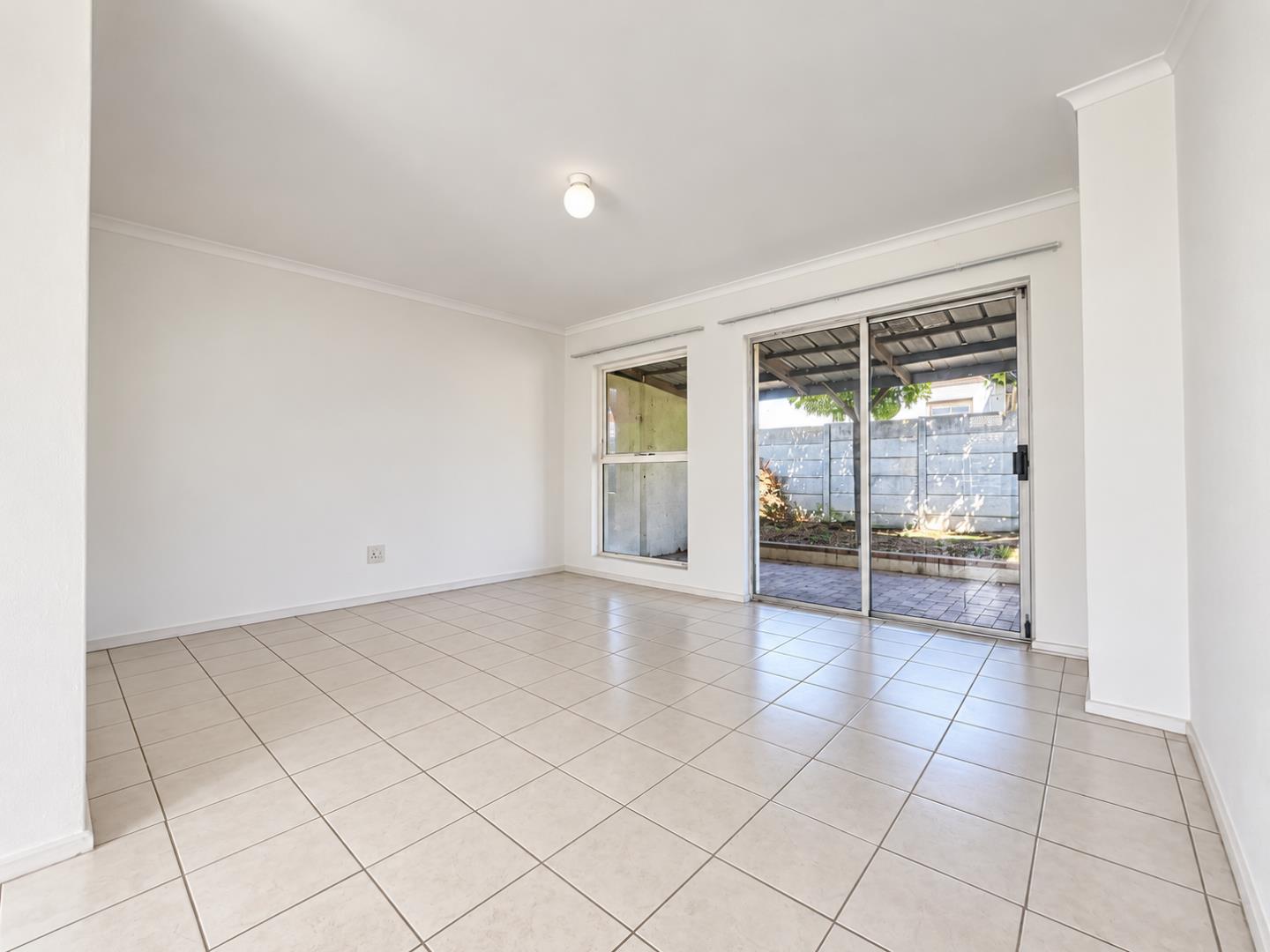 769853_Bright_Empty_Living_Room_with_Patio_Views.png