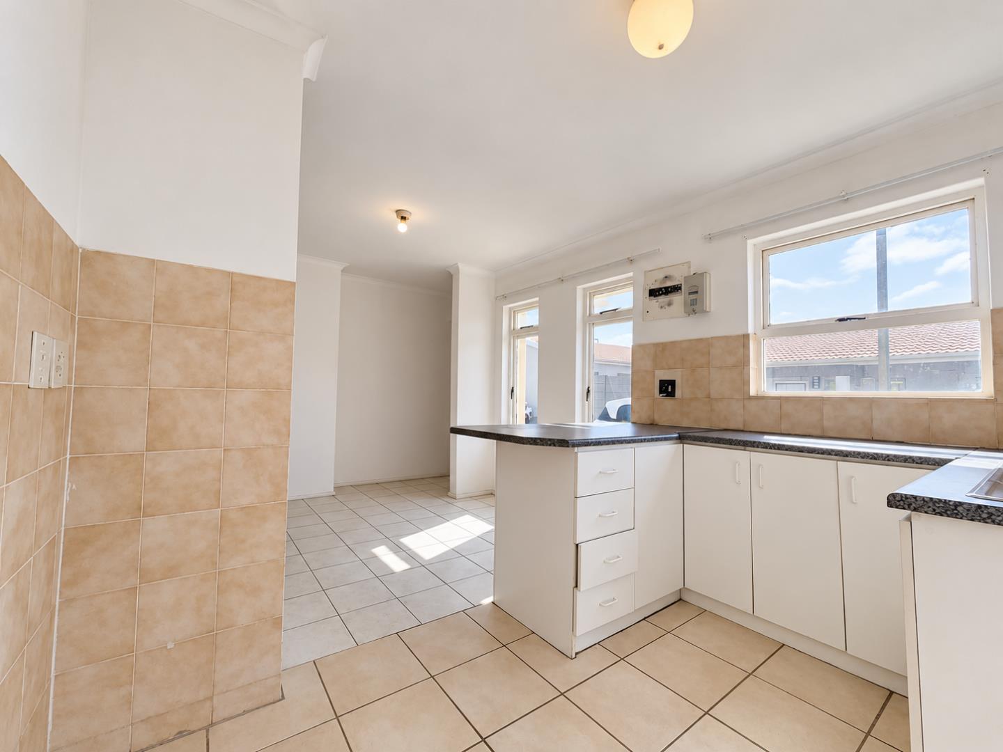 769853_Sunlit_Empty_Neutral-Tone_Kitchen_Interior.png
