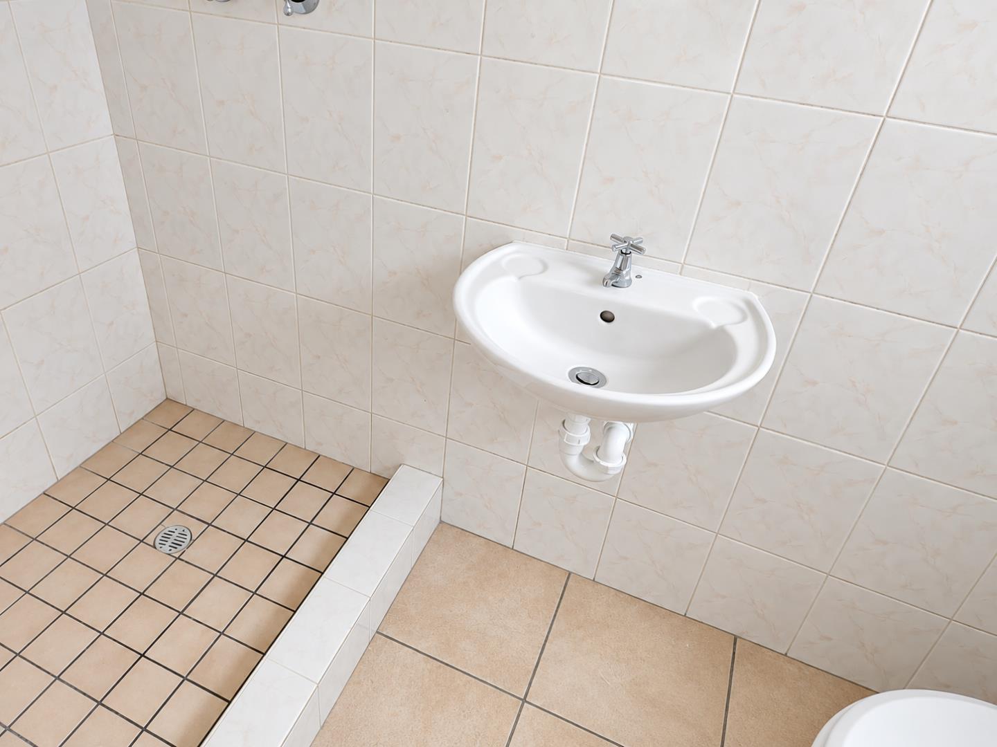 769856_Minimal_Cream-Tiled_Bathroom_with_Wall-Mounted_Sink.png